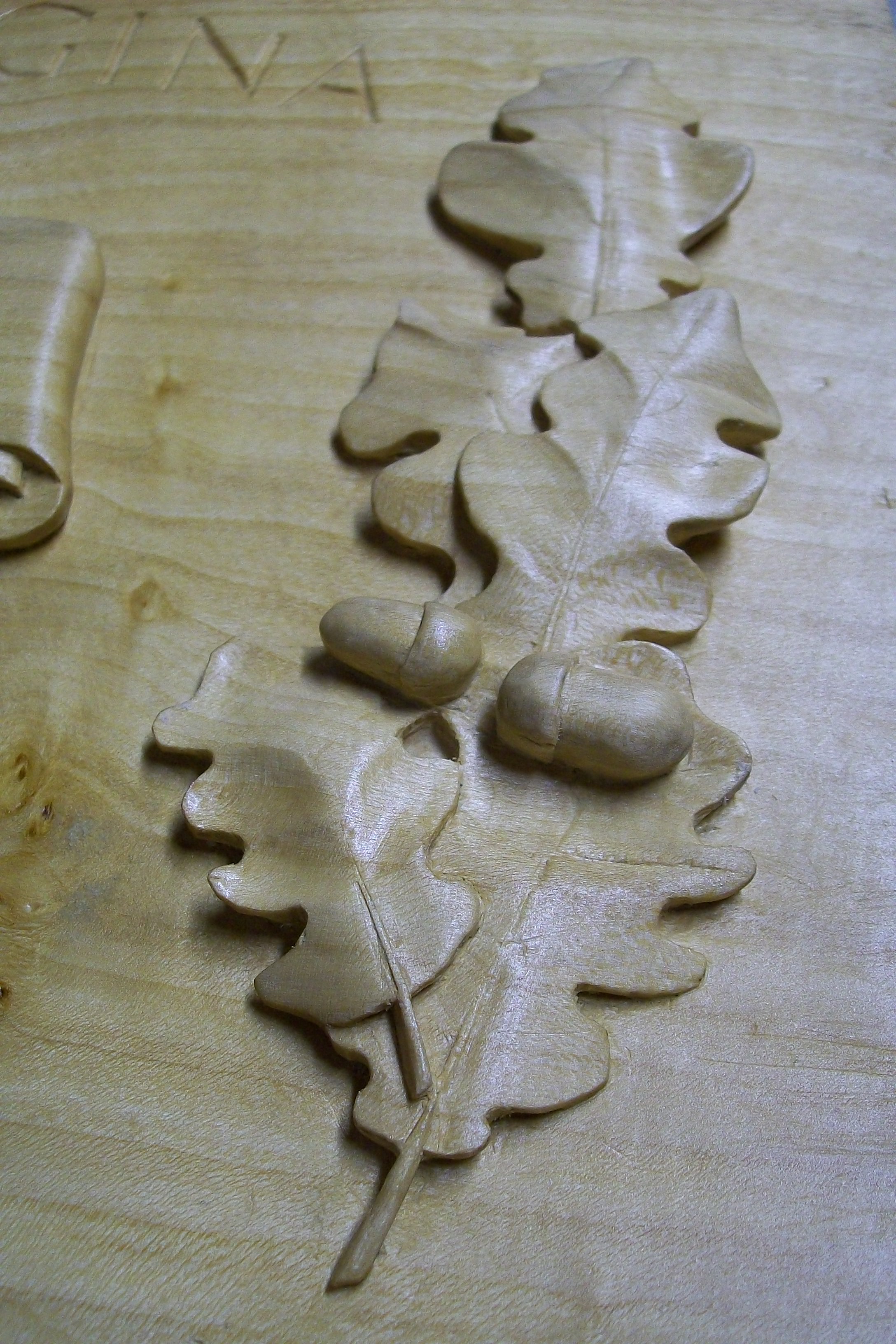 oak leaves and acorns, hand carved, lime wood, plaque, detail, bespoke carving, commemorative plaque,